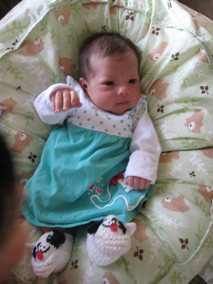 baby girl wearing hand crocheted booties from Manhattan Fruitier